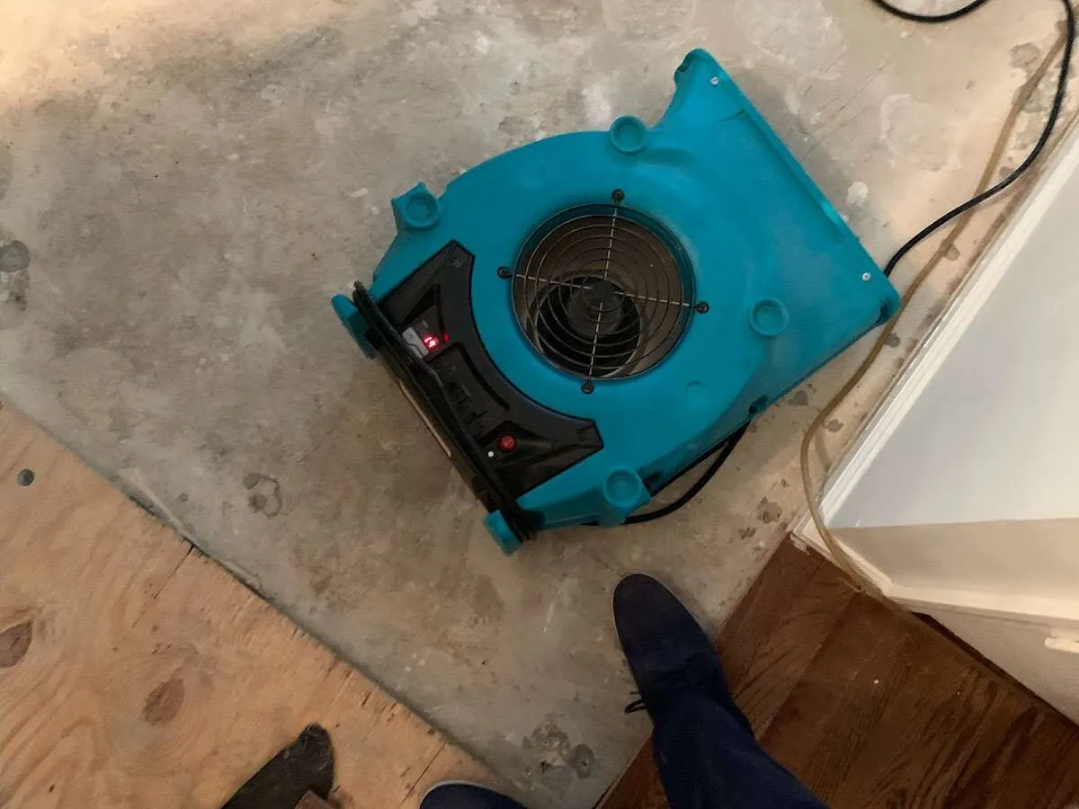 Air mover drying subfloor during Commercial Water Damage Restoration in West Hanover